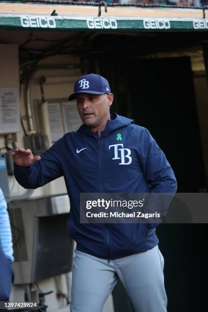 Manager Kevin Cash of the Tampa Bay Rays in the dugout before the game against the Oakland Athletics at RingCentral Coliseum on May 2, 2022 in...