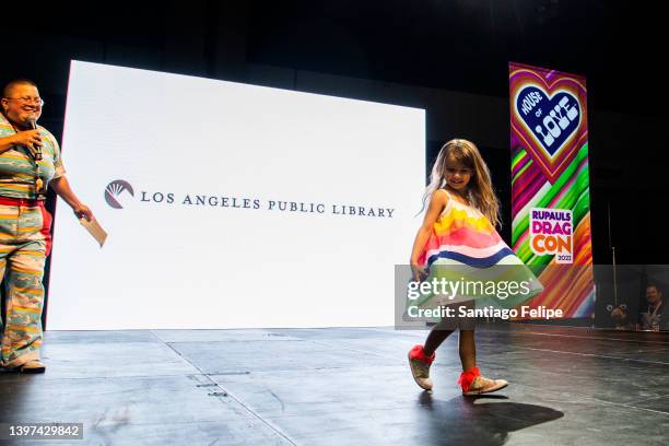 Child walks the catwalk during 'Kid's Fashion Show: Presented by LA Public Library ' on the 'House of Love' main stage during 'RuPaul's DragCon' at...