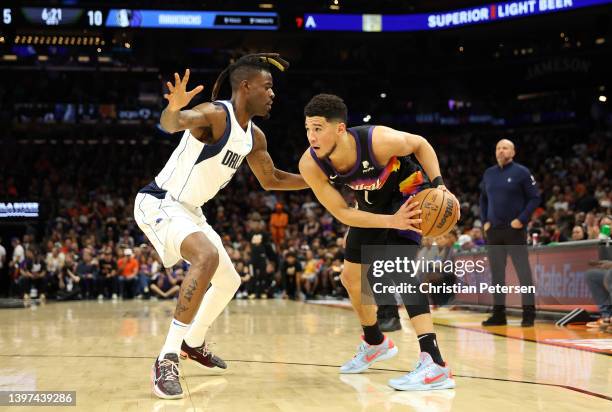 Devin Booker of the Phoenix Suns handles the ball against Reggie Bullock of the Dallas Mavericks during the first half in Game Seven of the 2022 NBA...