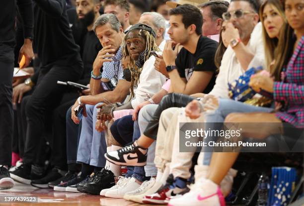 Rapper Lil Wayne attends Game Seven of the 2022 NBA Playoffs Western Conference Semifinals between the Dallas Mavericks and the Phoenix Suns at...
