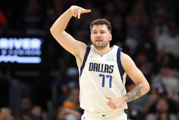 Luka Doncic of the Dallas Mavericks reacts after making a three point basket during the third quarter against the Phoenix Suns in Game Seven of the...