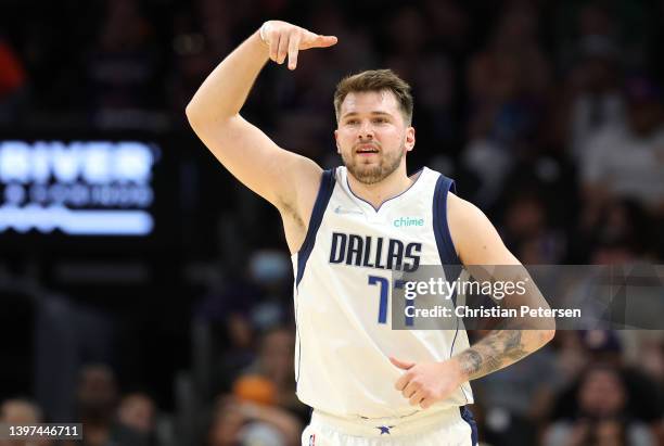 Luka Doncic of the Dallas Mavericks reacts after making a three point basket during the third quarter against the Phoenix Suns in Game Seven of the...