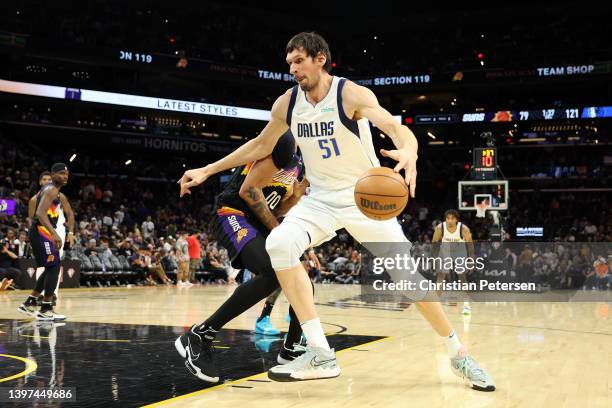 Boban Marjanovic of the Dallas Mavericks handles the ball against JaVale McGee of the Phoenix Suns during the fourth quarter in Game Seven of the...