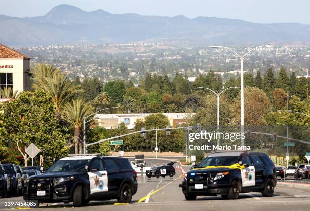 Police vehicles are parked near the scene of a shooting at the Geneva Presbyterian Church on May 15, 2022 in Laguna Woods, California. According to...