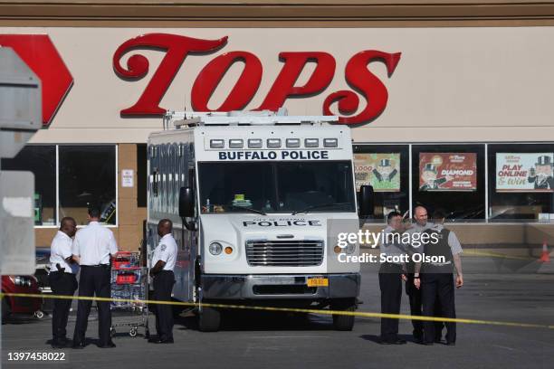 Police and FBI agents continue their investigation of the shooting at Tops market on May 15, 2022 in Buffalo, New York. A gunman opened fire at the...