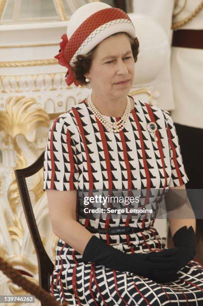 Queen Elizabeth II watches the entertainments aboard the Royal Yacht 'Britannia', upon her arrival in Fiji during her royal tour, 16th February 1977.