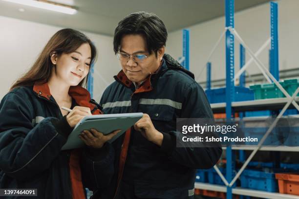 cold storage worker checking their stock, picking products. - cold storage room stock pictures, royalty-free photos & images