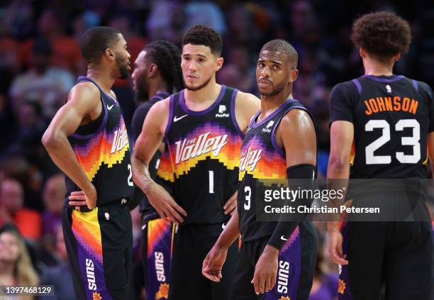 Chris Paul of the Phoenix Suns stands on the court with Mikal Bridges, Devin Booker and Cameron Johnson during the first half of Game Seven of the...