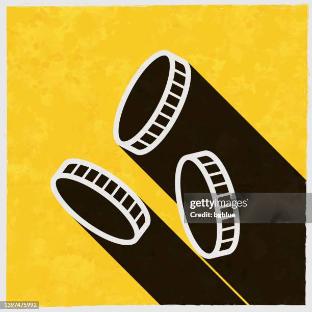 coins falling. icon with long shadow on textured yellow background - paper token stock illustrations