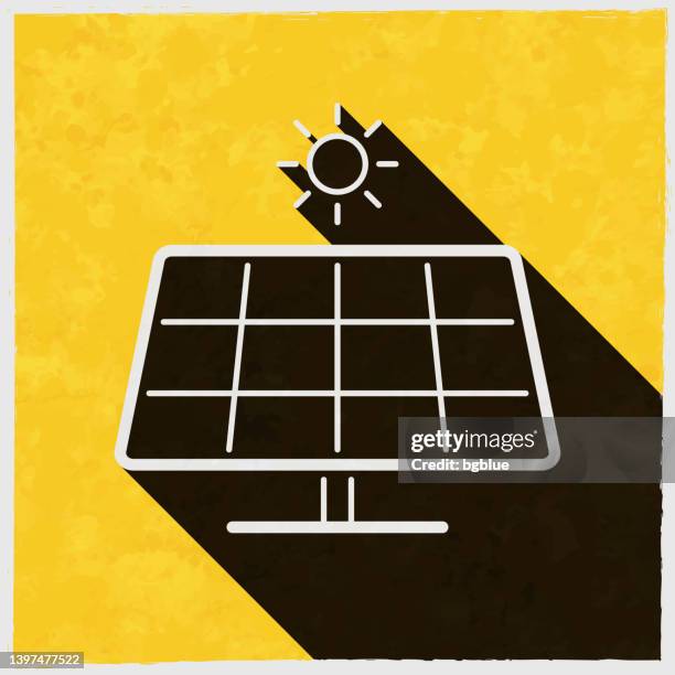 solar panel with sun. icon with long shadow on textured yellow background - solar panel texture stock illustrations