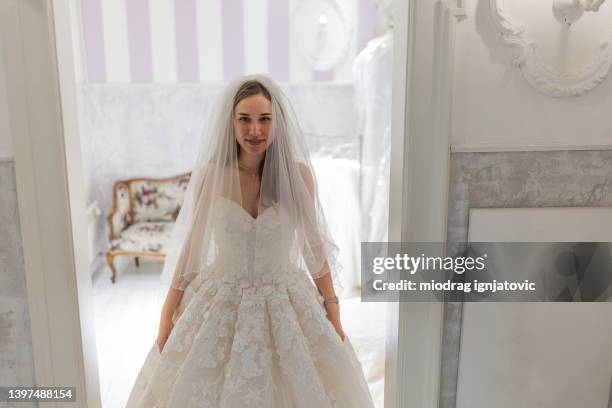 portrait of woman in a wedding dress at the bridal shop - wedding veil stock pictures, royalty-free photos & images