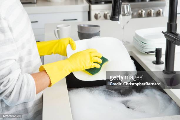 hand washing dishes - rubber gloves stockfoto's en -beelden