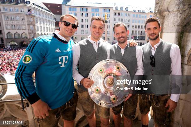 Manuel Neuer, Christian Fruechtl, Toni Tapalovic and Sven Ulreich of Bayern Muenchen pose with a championship trophy during the official Bundesliga...