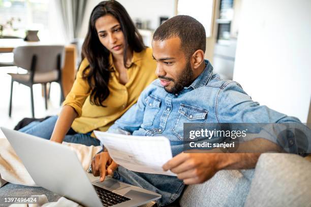 young couple planning their finances together - couple looking up stock pictures, royalty-free photos & images