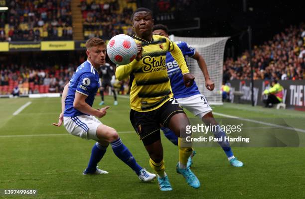Samuel Kalu of Watford FC battles for possession with Harvey Barnes and James Justin of Leicester City during the Premier League match between...
