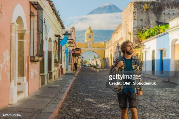 woman walking in antigua - guatemala city metropolitan cathedral stock pictures, royalty-free photos & images