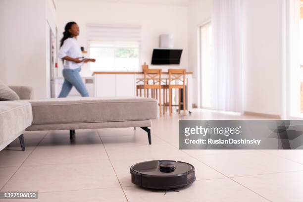 mobile control of robot vacuum cleaner. - scrubbing stock pictures, royalty-free photos & images