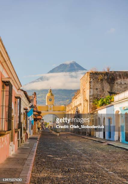 antigua on the background of agua volcano at sunrise - antigua guatemala stock pictures, royalty-free photos & images