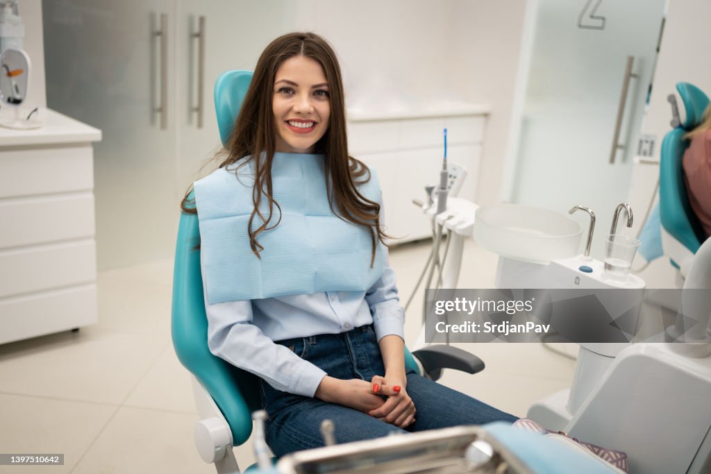 Caucasian female patient sitting on the dentist's chair at the dental clinic