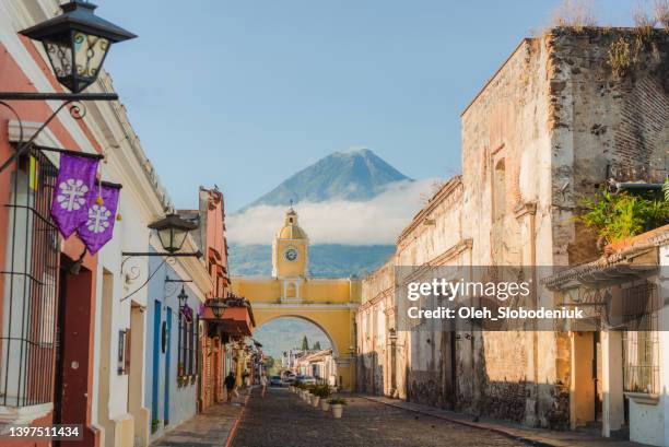 antigua on the background of agua volcano at sunrise - antigua western guatemala stock pictures, royalty-free photos & images