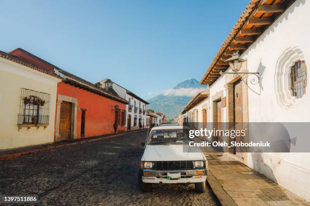 pickup on streets of antigua at sunrise - guatemala landscape stock pictures, royalty-free photos & images