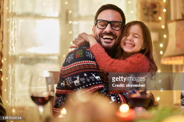 affectionate single father and daughter embracing on christmas day. - family new year's eve stock pictures, royalty-free photos & images