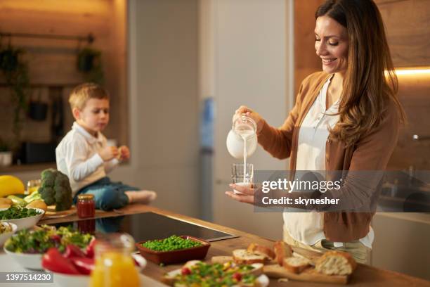 pouring fresh milk for my little boy! - glass of milk stock pictures, royalty-free photos & images