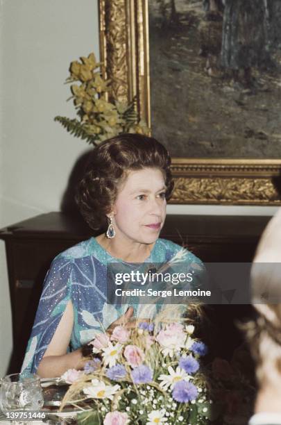Queen Elizabeth II attends a formal dinner, circa 1978.