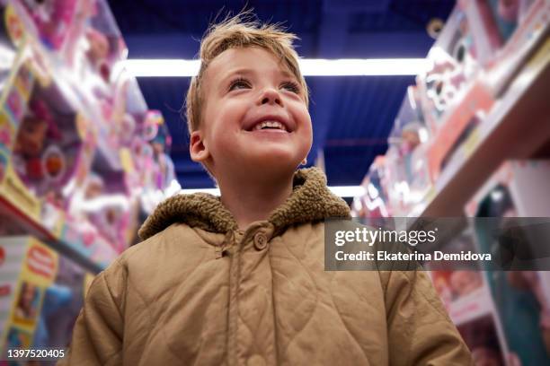 child boy happy in toy store portrait - mini grocery store photos et images de collection