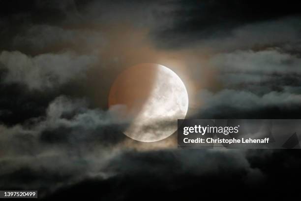 beautiful partial lunar eclipse on may 2022, france - eclipse lunar stock pictures, royalty-free photos & images