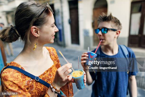 teenage girl and her brother are trying cold and tasty granita ice cream. - trying new food stock pictures, royalty-free photos & images