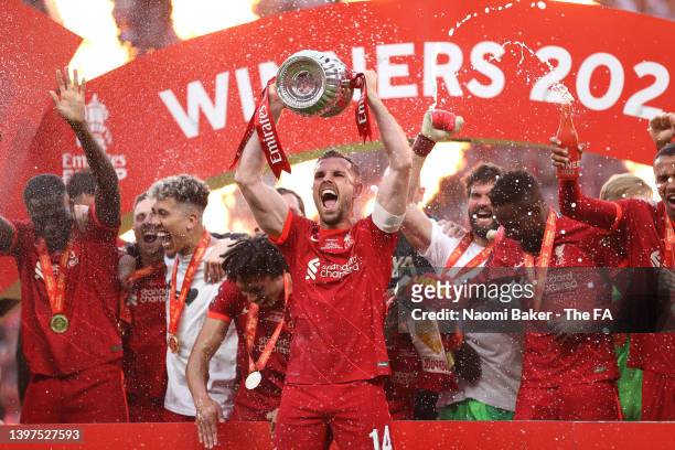 Jordan Henderson of Liverpool lifts The Emirates FA Cup trophy after their sides victory following The FA Cup Final match between Chelsea and...