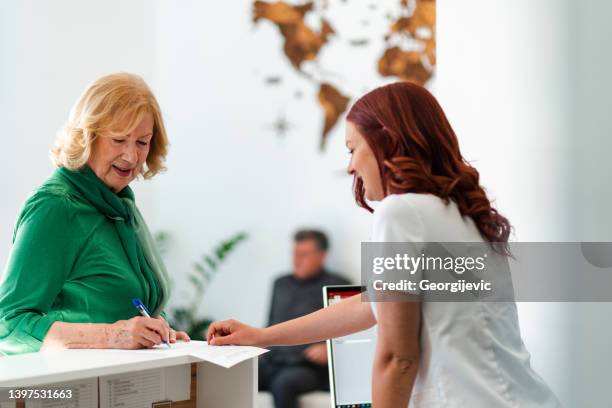 reception desk at the medical clinic - old receptionist stock pictures, royalty-free photos & images