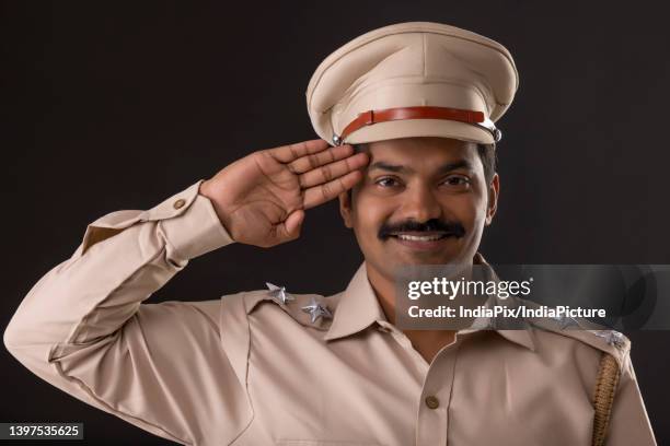 close-up portrait of an indian policeman saluting - indian police officer image with uniform stockfoto's en -beelden