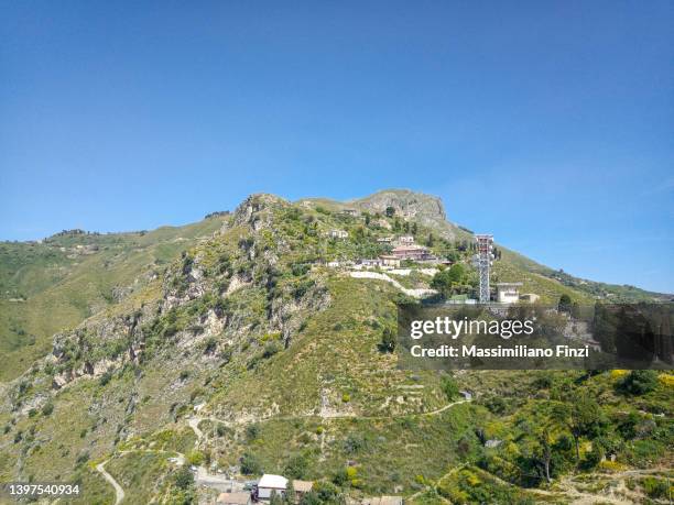 scenic view of the venere peak over the castelmola village - castelmola stock pictures, royalty-free photos & images