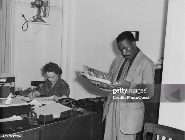 American photographer and photojournalist Gordon Parks as he reads a copy of 'Yank,' the US Army's weekly magazine, in the Farm Security...