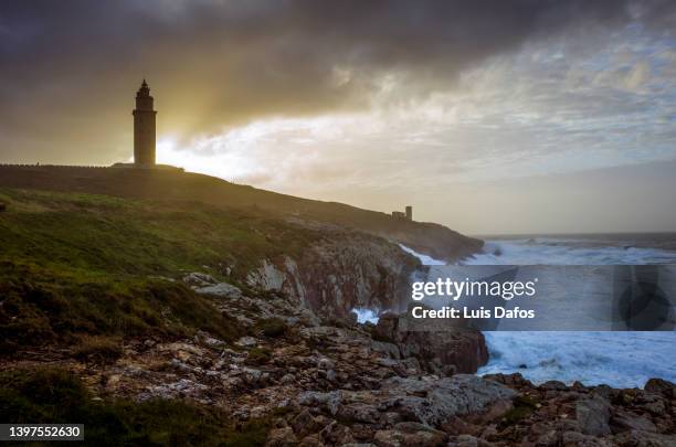 tower of hercules roman lighthouse at sunset - a coruna stock pictures, royalty-free photos & images