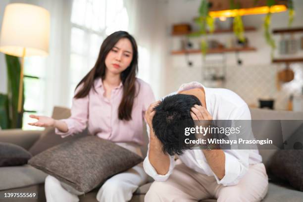 stressed young married family couple arguing, blaming each other. - asian couple arguing stock-fotos und bilder