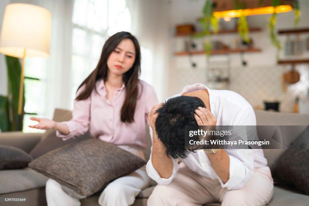 Stressed young married family couple arguing, blaming each other.