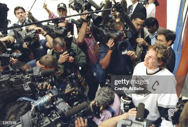 Center Wayne Gretzky of the Los Angeles Kings is surrounded by photographers after breaking the all-time NHL goal scoring record in the game against...