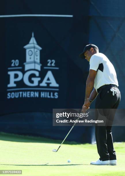 Tiger Woods of the United States putts on the 14th green during a practice round prior to the start of the 2022 PGA Championship at Southern Hills...