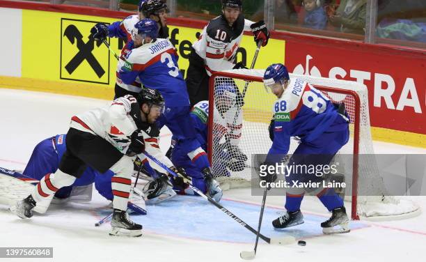 Pierre-Luc Dubois of Team Canada in action with Kristian Pospisil of Team Slovakia during the 2022 IIHF Ice Hockey World Championship Group A match...