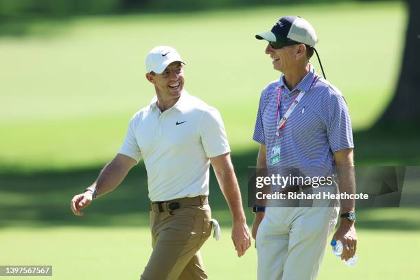 Rory McIlroy of Northern Ireland walks with Brad Faxon during a practice round prior to the start of the 2022 PGA Championship at Southern Hills...