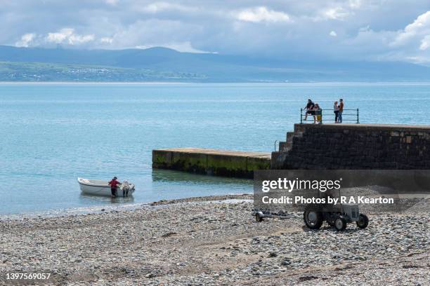 boat and tractor on the beach at criccieth, lleyn peninsula. may 2022. - tremadog bay stock pictures, royalty-free photos & images