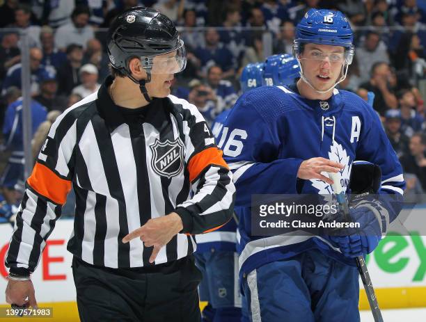 Referee Wes McCauley explaind a call to Mitchell Marner of the Toronto Maple Leafs prior to play resuming against the Tampa Bay Lightning during Game...
