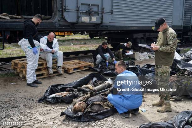 Ukrainian forensic experts describe the bodies of dead Russian soldiers, who died in settlements north of Kharkiv, on May 14, 2022 in Kharkiv,...