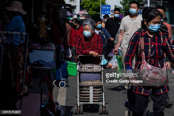The residents wear masks while shopping in the open market on May 162022 in Wuhan, Hubei Province, China. According to local media reports, Wuhan has...