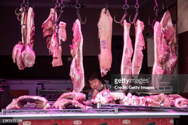 Pork vendor takes a nap in the open market on May 16, 2022 in Wuhan, Hubei Province, China. According to local media reports, Wuhan has implemented a...