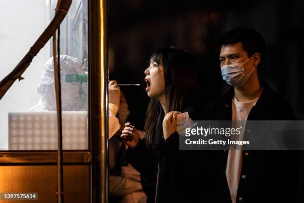 Health worker takes a swab sample from a resident to test for the Covid-19 coronavirus on May 16, 2022 in Wuhan, Hubei Province, China. According to...