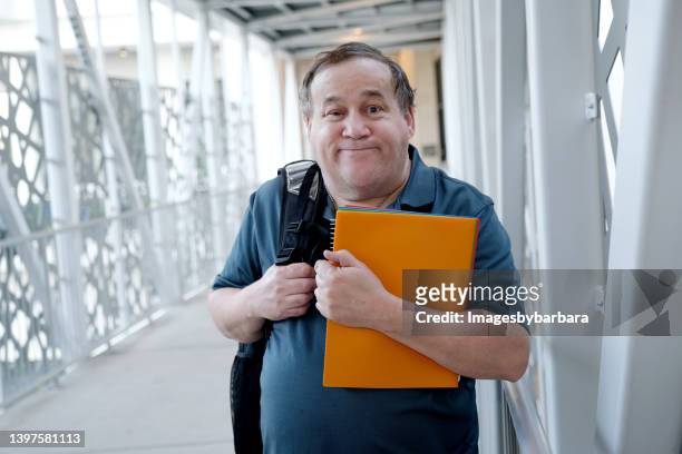 a autistic man with learning disabilities shows you can accomplish any task like going back to school if you put your mind to it. - learning difficulty stock pictures, royalty-free photos & images